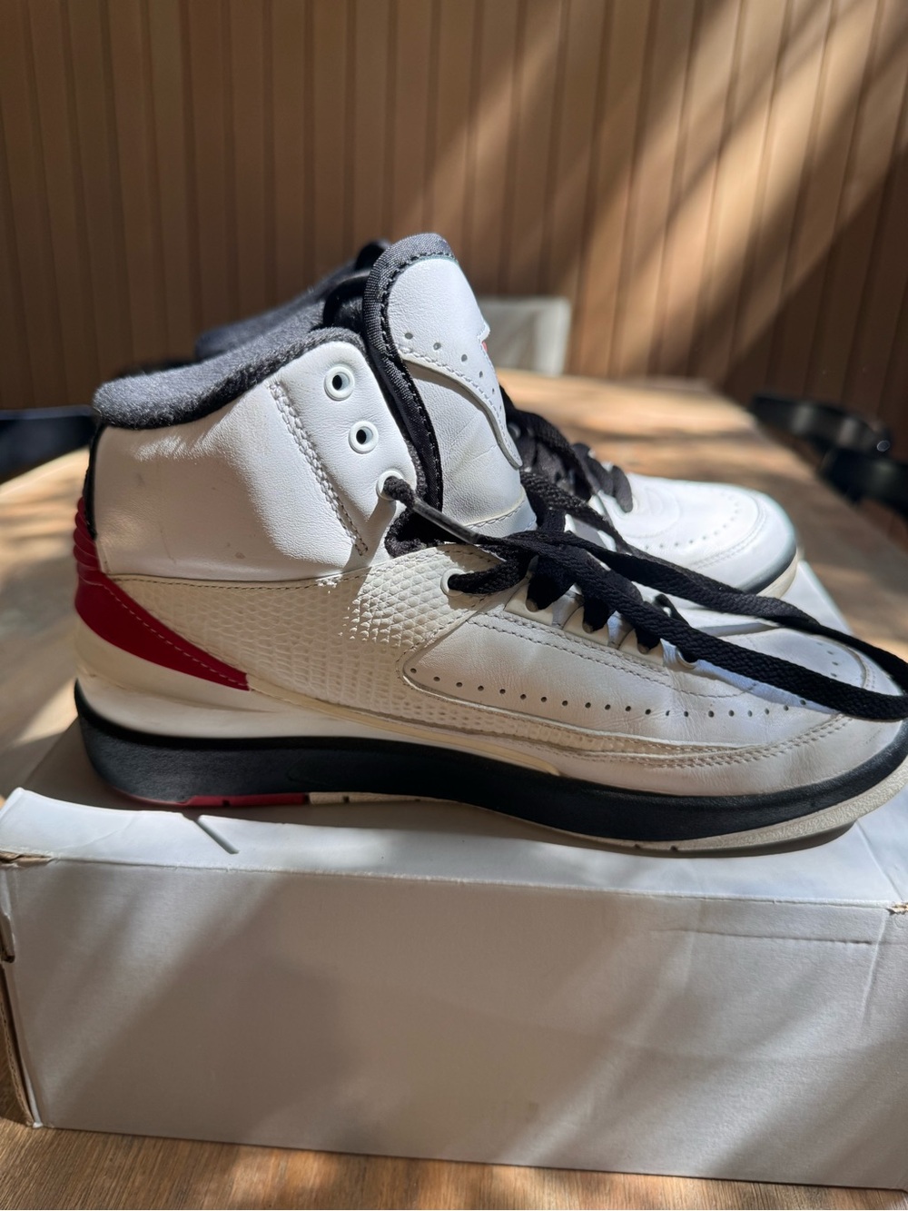 Nike White and Black High-Top Sneakers with Red Heel Accent